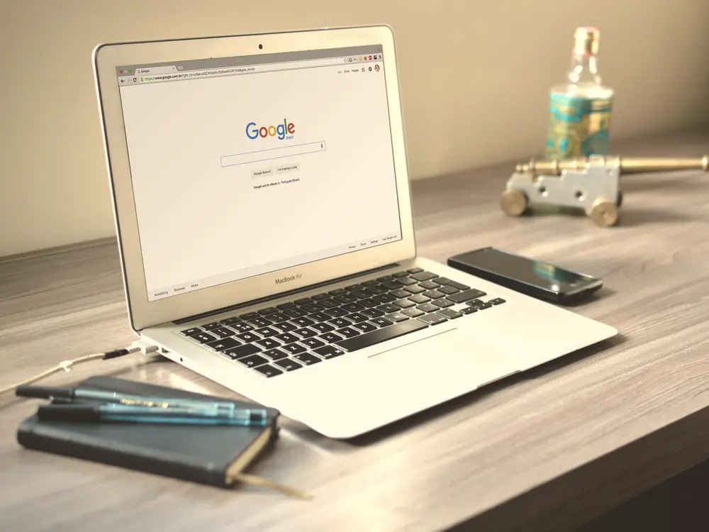 Laptop showing a Google search page on a desk