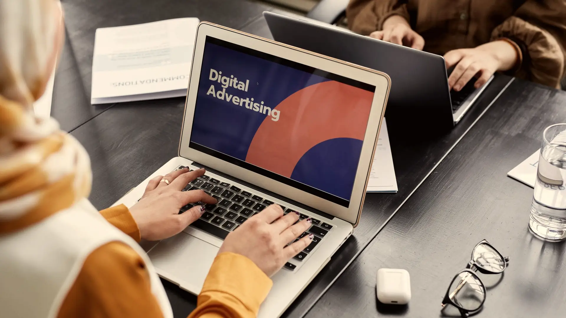 Team working on a laptop displaying a digital advertising campaign