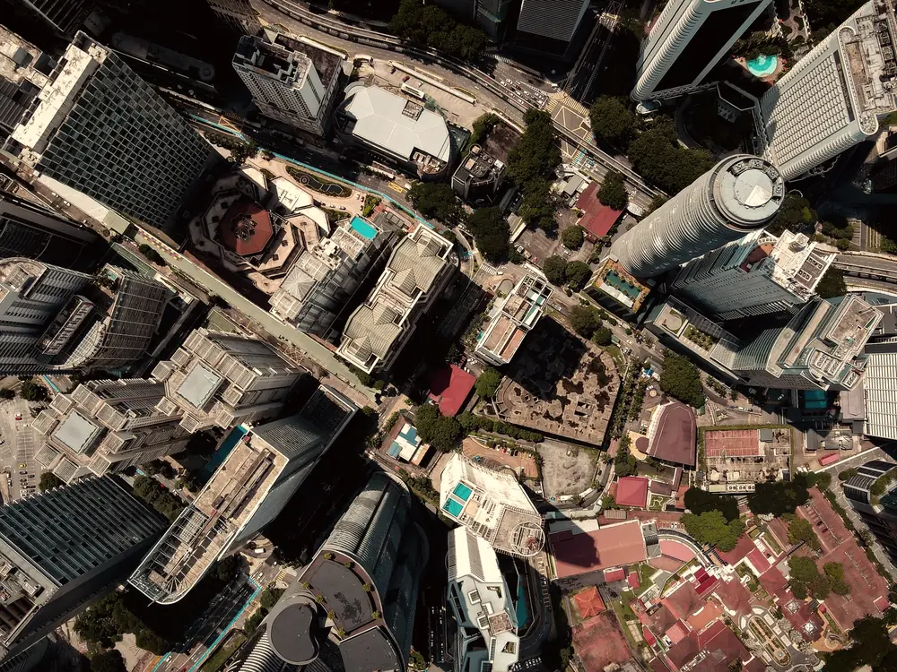 Aerial view of city towers with rooftop pools and hotel buildings